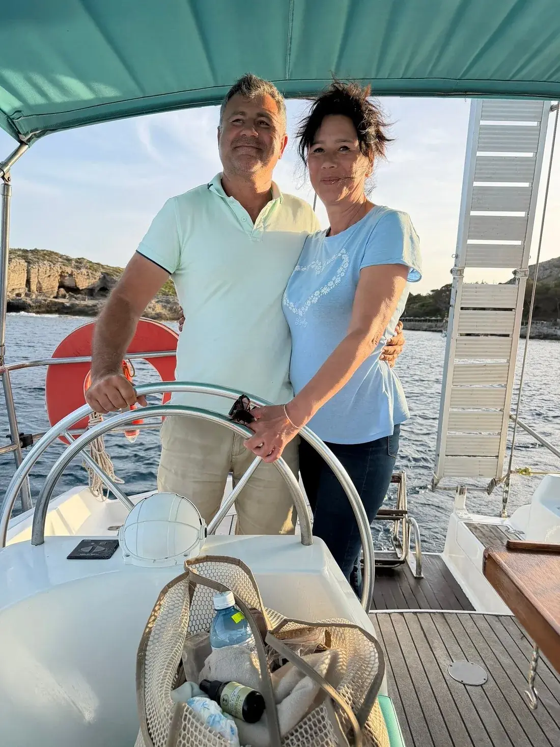 Simi and Flori at the wheel of sailing yacht Nikolaos in the evening light