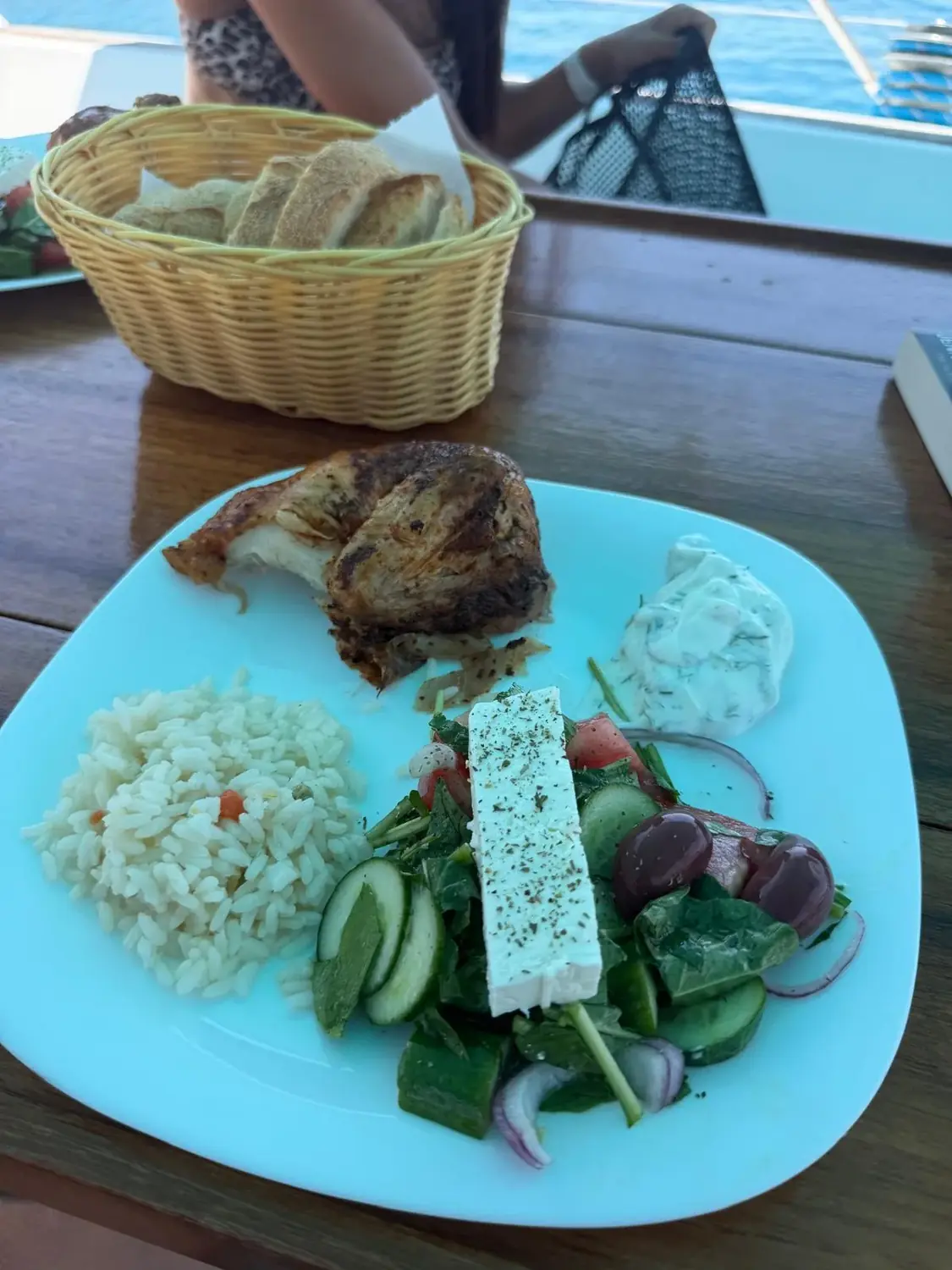 Roast chicken, rice, Greek salad with feta and tzatziki served on board